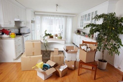 People moving boxes and furniture into storage near Uxbridge